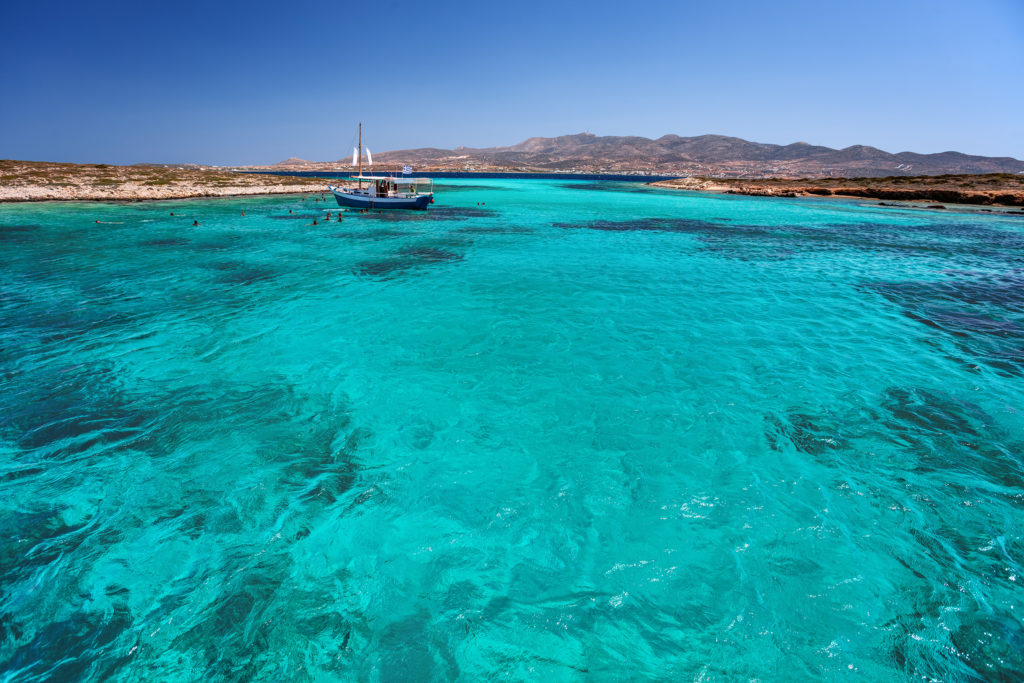 Blue lagoon in Tigani islet between Paros and Antiparos islands, Cyclades, Greece, with clear transparent turquoise waters.
